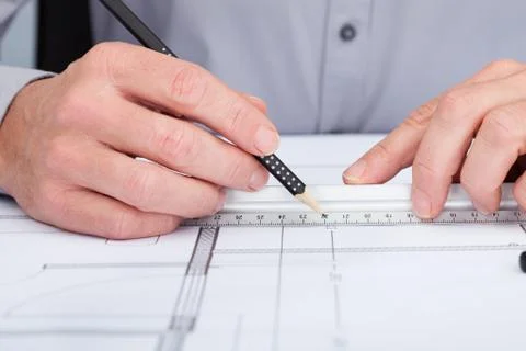 Architect drawing on blueprint Fotos de archivo