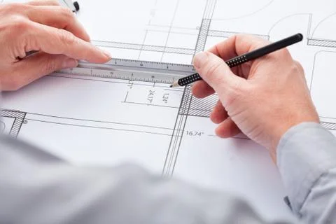 Architect drawing on blueprint Fotos de archivo