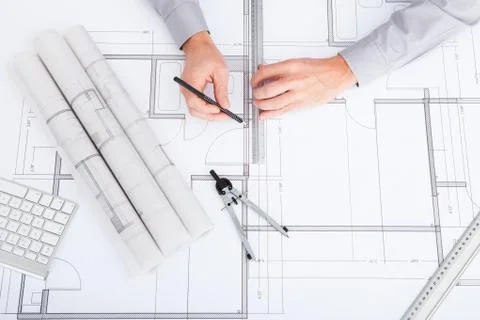 Architect drawing on blueprint Fotos de archivo