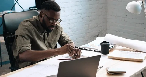 Architect drawing blueprints with professional Compass in Loft office.  Stock Footage 126235643