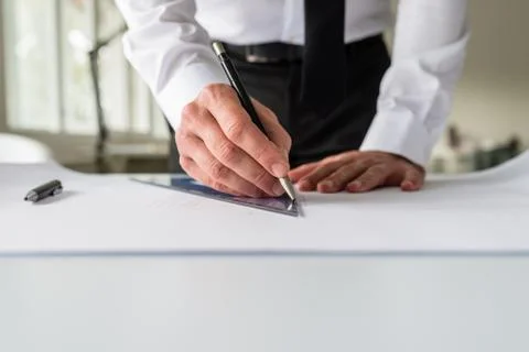 Architect drawing a draft on a paper Stock Photos
