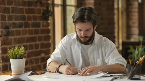 Architect Drawing a Plan 库存影片 92695474