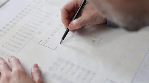 Architect drawing a plan on tracing paper Stock Footage 125873025