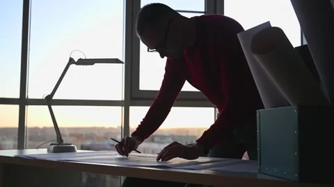 Architect draws blueprints on table Stock Footage 143415668