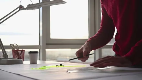 Architect draws blueprints on table Stock Footage 143481698