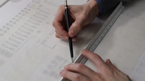 Architect draws a line on a blueprint using a ruler Stock Footage 125873004