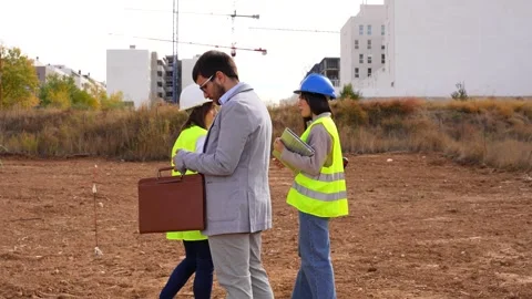Architect, engineer, and investor making a call while meeting at a construction Stock Footage 334553870