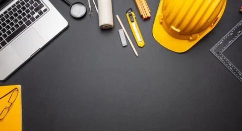 Architect engineer construction site office desk. Project blueprints, yellow Stock Photos