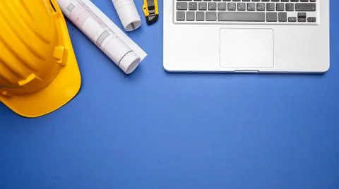 Architect engineer construction site office desk. Project blueprints, yellow Stock Photos