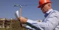 Architect Engineer Examines Paper Plan Office Building Construction Heavy Crane 4k or 4k+ Resolution