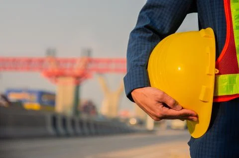 Architect Engineer holding hard hat road construction background Stock Photos