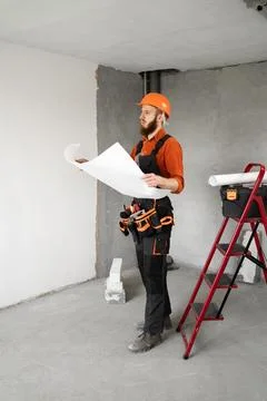 Architect, engineer or builder in hard hat holding house construction bluep.. Stock Photos