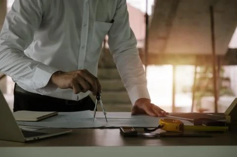 Architect, engineer or interior hands drawing with divider compass on blueprint Stock Photos