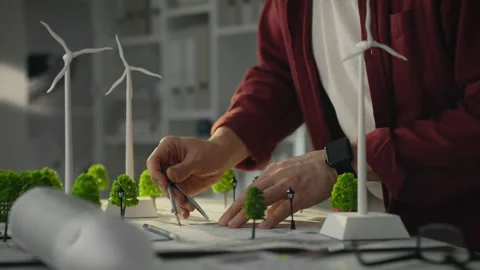 An architect-engineer plans the location of wind turbines and develops a con 스톡 동영상 285188212