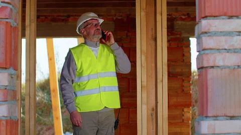 Architect engineer using mobile cell phone communications control process on Stock Photos