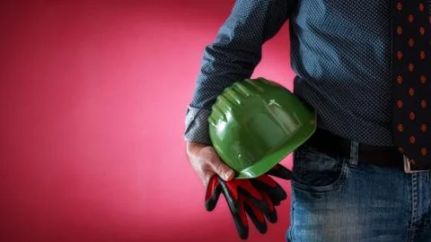 Architect engineer worker with helmet and gloves in hand. Building. Stock Photos