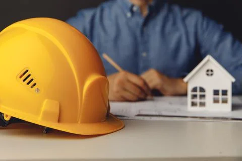 Architect engineer working on blueprint at his office Stock Photos