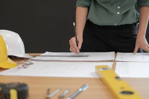 Architect engineer working on house blueprint of real estate project at workp Stock Photos