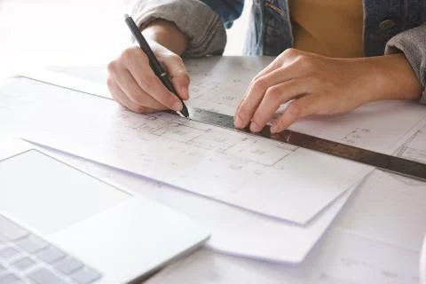 Architect engineer working on house blueprint of real estate project at workp Stock Photos
