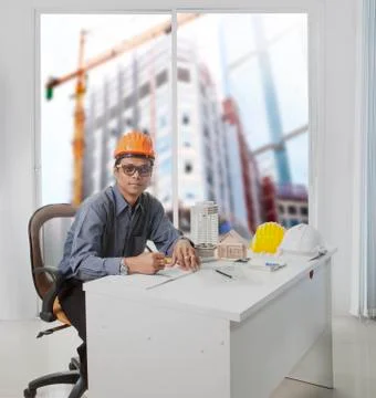 Architect engineer working in office room against building construction throu Stock-Fotos