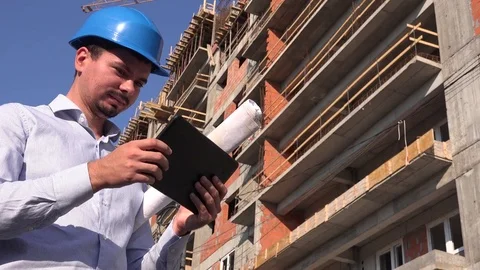 Architect engineer working outdoors with tablet blueprint 4K real estate builder Stock Footage 78505067