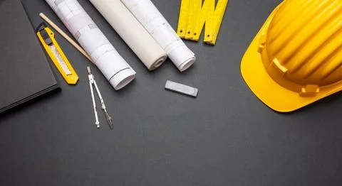 Architect engineer workplace, construction site desk. Project blueprints, yel Stock Photos