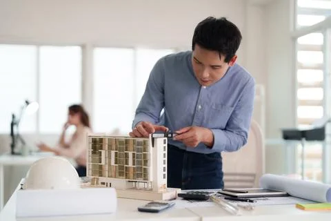 Architect engineering professional measuring scale model building modern ur.. Stock Photos