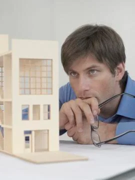An architect examining an architectural model Stock Photos