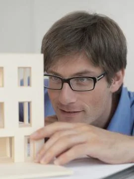 An architect examining an architectural model Stock Photos