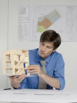 An architect examining an architectural model Stock Photos