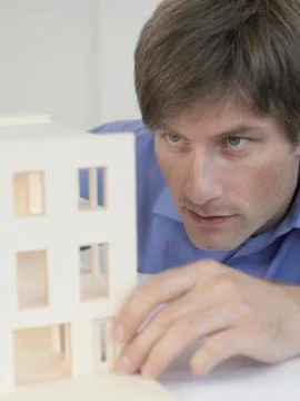 An architect examining an architectural model Stock Photos