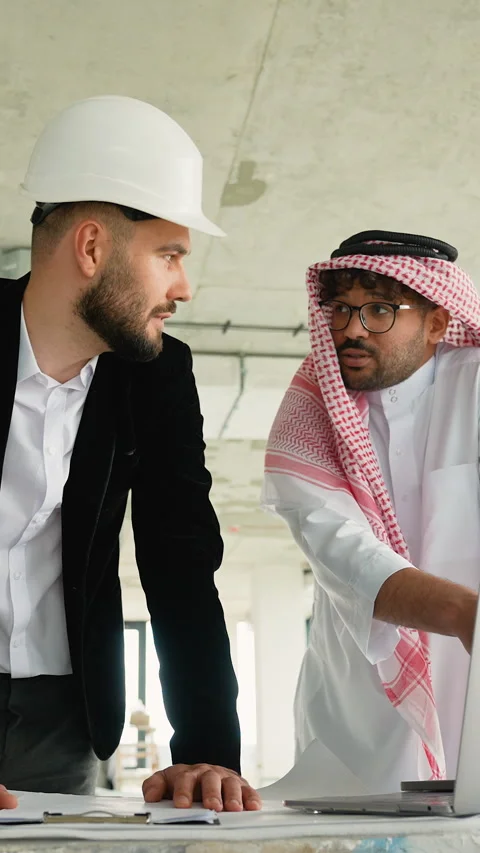 Architect explaining blueprint to Arab investor in construction site Stock Footage 316746421