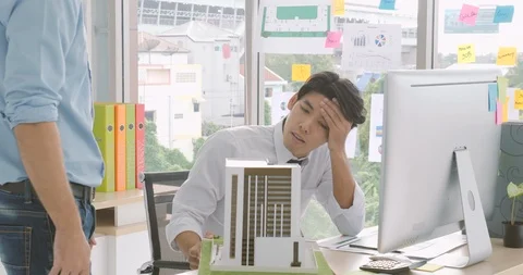 Architect feeling serious when his project not approved. Manager rejects for Stock Footage 92183615