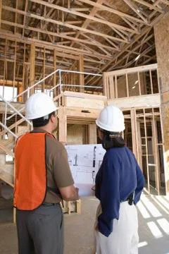 Architect With Foreman Examining Framework Stock Photos