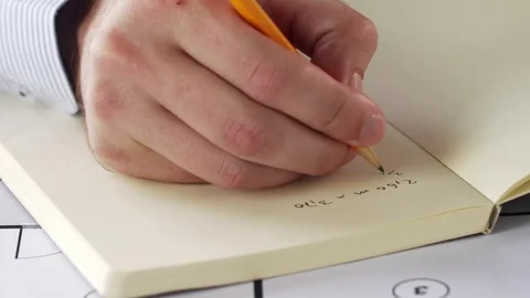 Architect hand with blueprint writing to notebook Stock Footage