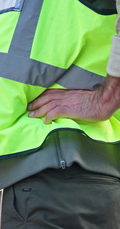 Architect, hands and injury with back pain on construction site for overworked Stock Footage 340952583