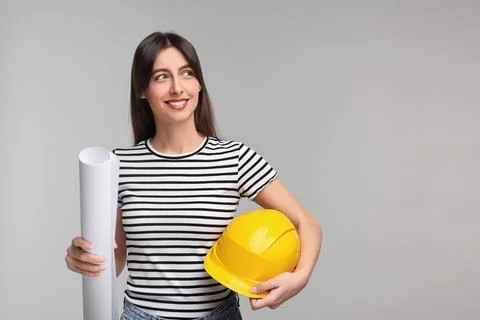 Architect with hard hat and draft on light grey background, space for text Stock Photos