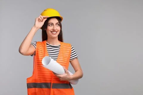 Architect in hard hat with draft on light grey background, space for text Stock Photos