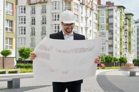 Architect in hardhat looking at construction projects. Stock Photos