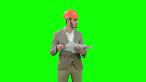Architect in helmet checking construction plan on a Green Screen, Chroma Key Stock Footage 71203839