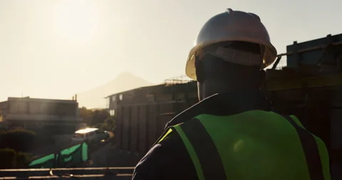 Architect, helmet or thinking with building on construction site space for Stock Footage 336797405