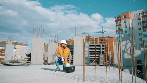 Architect in helmet with toolbox and screwdriver relaxing at work Video stock 247771832