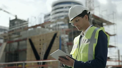 Architect in helmet using tablet on construction site Stock Footage 167095051