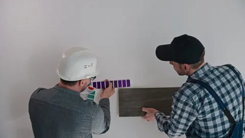 The architect, with the help of a construction engineer, selects materials for Stock Footage 268610208