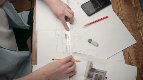 Architect at his desk. House project. man designs a house. architect's workplace Stock Footage 165687312