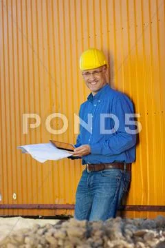 Architect holding blueprints and digital tablet Stock Photos