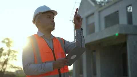 Architect inspector walking with white safety helmet in construction site. Confi Stock Footage 240118044