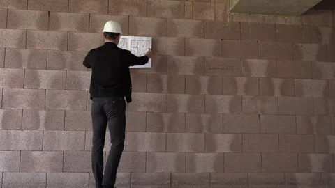 Architect inspects construction from the inside Stock Footage 107558640