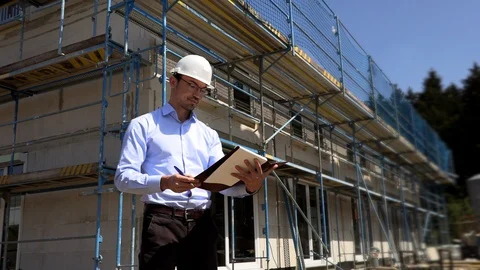Architect inspects construction outside talking on the phone 動画素材 107559386