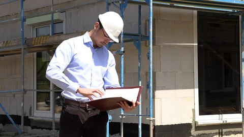Architect inspects construction outside talking on the phone Stock-Footage 107560040